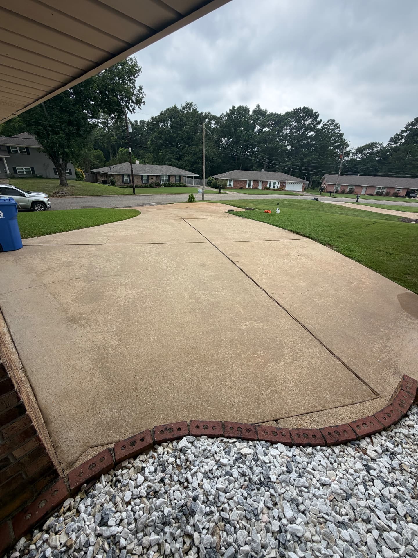 Same concrete driveway after pressure washing, clean and uniform